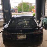 Back view of a Tesla in the repair shop