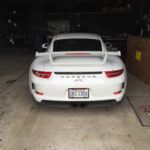 Back view of a Porsche in the repair shop